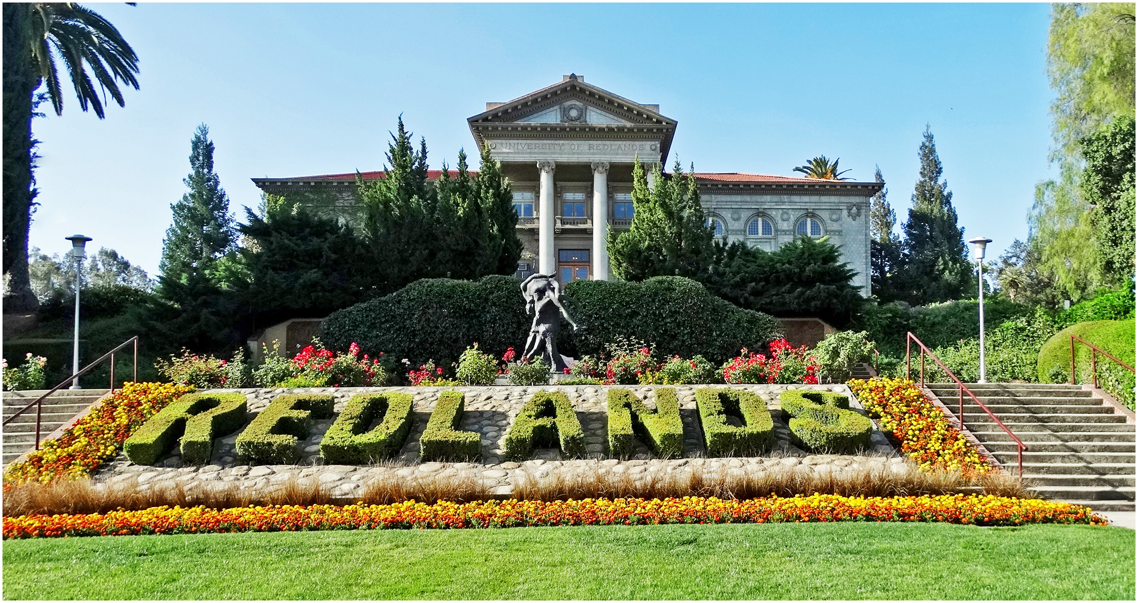 The University of Redlands administration building framed by landscaped campus gardens